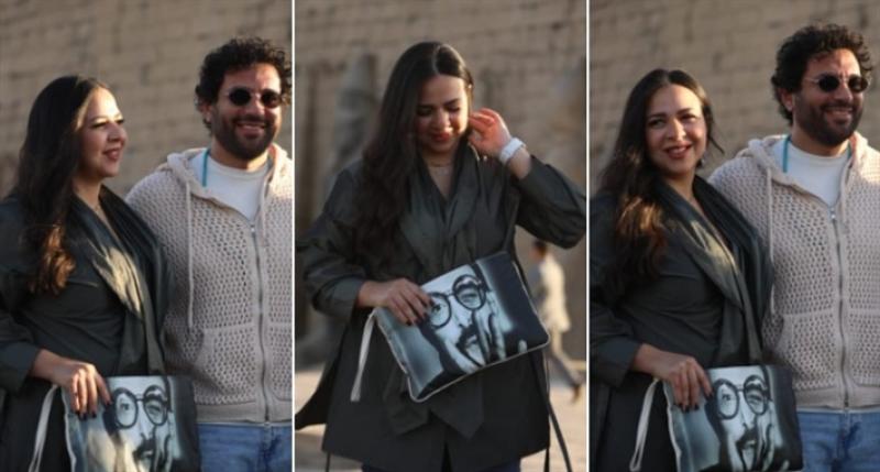 إيمي سمير غانم بحقيبة تحمل صورة والدها 
