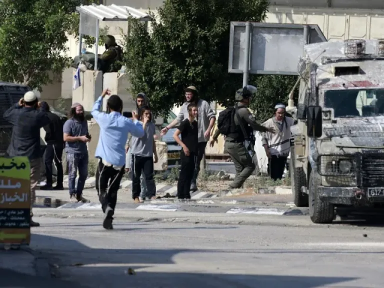 مستوطنون يهاجمون منازل في بلدة بيت أمر تحت أنظار جنود الاحتلال